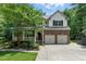 Charming two-story home with brick accents, attached two-car garage, well-manicured lawn, and inviting front porch at 776 Legend Oaks Dr, Chapel Hill, NC 27517