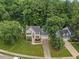 Aerial view of home shows impeccable landscaping, mature trees and a pristine lawn at 7808 Sandy Bottom Way, Raleigh, NC 27613