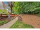 Backyard has mature landscaping, a deck and a well-manicured lawn at 7808 Sandy Bottom Way, Raleigh, NC 27613