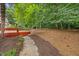 Backyard with mature landscaping, a deck and a walkway at 7808 Sandy Bottom Way, Raleigh, NC 27613