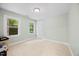 Bedroom with neutral carpet, natural light from two windows, and ample space at 7808 Sandy Bottom Way, Raleigh, NC 27613