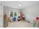 Neutral bedroom with a window view, carpeted floors, and storage at 7808 Sandy Bottom Way, Raleigh, NC 27613