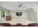 Bonus room with television, reclining chairs, carpet, ceiling fan, and a bright window at 7808 Sandy Bottom Way, Raleigh, NC 27613