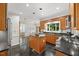 A second look at the kitchen, featuring sleek appliances, ample wood cabinetry, and granite countertops at 7808 Sandy Bottom Way, Raleigh, NC 27613