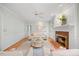 Spacious living room with a brick fireplace, hardwood floors, and elegant decor creating a comfortable and stylish space at 7808 Sandy Bottom Way, Raleigh, NC 27613