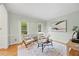 Bright living room with hardwood floors, decorative molding, and a large rug creating a cozy and elegant atmosphere at 7808 Sandy Bottom Way, Raleigh, NC 27613