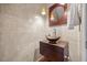 Stylish powder room featuring a unique sink and modern fixtures at 7808 Sandy Bottom Way, Raleigh, NC 27613