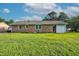 Spacious backyard featuring lush green grass, a brick exterior, and several large windows at 801 Lincoln Dr, Rocky Mount, NC 27801