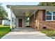 Attached carport features a concrete floor, brick and siding, and a doorway for easy access at 801 Lincoln Dr, Rocky Mount, NC 27801