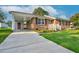 Traditional brick home with a concrete driveway, covered carport, and well-maintained lawn at 801 Lincoln Dr, Rocky Mount, NC 27801