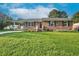 Charming brick home featuring a well-manicured lawn and a convenient carport at 801 Lincoln Dr, Rocky Mount, NC 27801