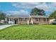 Charming brick home featuring a well-manicured lawn and a convenient carport at 801 Lincoln Dr, Rocky Mount, NC 27801