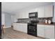 Modern kitchen featuring white cabinets and dark backsplash at 801 Lincoln Dr, Rocky Mount, NC 27801