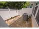 Fenced backyard area with stone pavers and manicured landscaping at 809 Davidson Point Rd, Cary, NC 27513