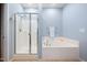 Bathtub with glass shower door at 809 Davidson Point Rd, Cary, NC 27513