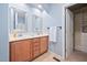 Double sink bathroom with a large mirror and a storage closet at 809 Davidson Point Rd, Cary, NC 27513