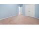 Comfortable bedroom featuring soft blue walls, plush carpeting, double door closet, and entryway for easy access at 809 Davidson Point Rd, Cary, NC 27513