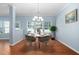 Open dining area with hardwood floors and stylish virtual staging at 809 Davidson Point Rd, Cary, NC 27513