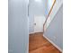 Entryway featuring wood floors, stairs, and a bright white door at 809 Davidson Point Rd, Cary, NC 27513
