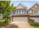 Charming townhouse with stone accents, attached garage, and manicured landscaping at 809 Davidson Point Rd, Cary, NC 27513