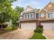 Townhouse featuring gray siding, a stone base, and a well-maintained front yard at 809 Davidson Point Rd, Cary, NC 27513