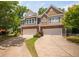 Street view of townhouses with well-maintained landscaping and private driveways at 809 Davidson Point Rd, Cary, NC 27513