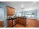 Modern kitchen with wood cabinets, tile backsplash, and stainless steel dishwasher at 809 Davidson Point Rd, Cary, NC 27513