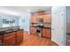 Functional kitchen featuring stainless steel appliances and wood cabinets at 809 Davidson Point Rd, Cary, NC 27513