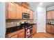 Cozy kitchen featuring stainless steel appliances and wood cabinets at 809 Davidson Point Rd, Cary, NC 27513