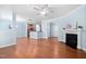Living room with hardwood flooring, open layout to kitchen, and fireplace at 809 Davidson Point Rd, Cary, NC 27513