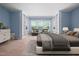 Digitally staged bedroom with soft neutral carpet, large windows, and built-in shelving at 809 Davidson Point Rd, Cary, NC 27513
