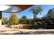 Scenic pond with stone edging and lush greenery, complemented by an elevated walkway and a clear blue sky backdrop at 809 Davidson Point Rd, Cary, NC 27513