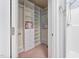 Spacious walk-in closet with built-in shelving and drawers, adjacent to an en-suite bathroom with a walk-in shower at 809 Davidson Point Rd, Cary, NC 27513