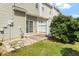 View of a grassy backyard and the building exterior at 8326 Glenwood Springs Ct, Raleigh, NC 27616