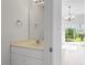 Well-lit powder room featuring vanity with sink and view of the backyard at 8326 Glenwood Springs Ct, Raleigh, NC 27616
