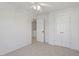 Bright bedroom features a ceiling fan, carpeted floor, and a closet for ample storage space at 8326 Glenwood Springs Ct, Raleigh, NC 27616