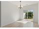 Bright dining room featuring modern lighting and sliding glass door leading to the backyard at 8326 Glenwood Springs Ct, Raleigh, NC 27616