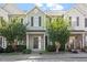 Inviting townhouse with light green siding, well-manicured landscaping, and a charming front entrance at 8326 Glenwood Springs Ct, Raleigh, NC 27616