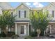 Inviting townhouse with light green siding, well-manicured landscaping, and a charming front entrance at 8326 Glenwood Springs Ct, Raleigh, NC 27616