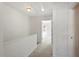 Bright hallway with neutral carpet and white walls leads to a bedroom, creating a clean and inviting space at 8326 Glenwood Springs Ct, Raleigh, NC 27616