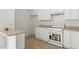 Well-lit kitchen featuring white cabinetry, light countertops, and a white oven at 8326 Glenwood Springs Ct, Raleigh, NC 27616