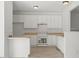 Well-lit kitchen features white cabinetry, light countertops, and modern appliances at 8326 Glenwood Springs Ct, Raleigh, NC 27616