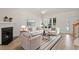Bright living room with fireplace, large windows, and stylish neutral-toned furniture at 8326 Glenwood Springs Ct, Raleigh, NC 27616