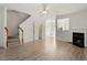 Bright living room featuring hardwood floors, staircase, and fireplace at 8326 Glenwood Springs Ct, Raleigh, NC 27616