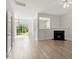 Bright living room featuring hardwood floors, fireplace, view to backyard and kitchen at 8326 Glenwood Springs Ct, Raleigh, NC 27616