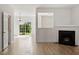 Bright living room with hardwood floors, a fireplace, and a view to the backyard at 8326 Glenwood Springs Ct, Raleigh, NC 27616