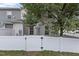 Fenced backyard view with grass and white fencing at 948 Consortium Dr, Raleigh, NC 27603