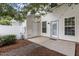 A view of the backyard with a concrete patio and doors to the townhome at 948 Consortium Dr, Raleigh, NC 27603
