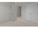 This is a carpeted secondary bedroom featuring closet, door, and neutral walls at 948 Consortium Dr, Raleigh, NC 27603
