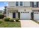 An exterior view of the two story townhome with attached garage and front yard landscaping at 948 Consortium Dr, Raleigh, NC 27603